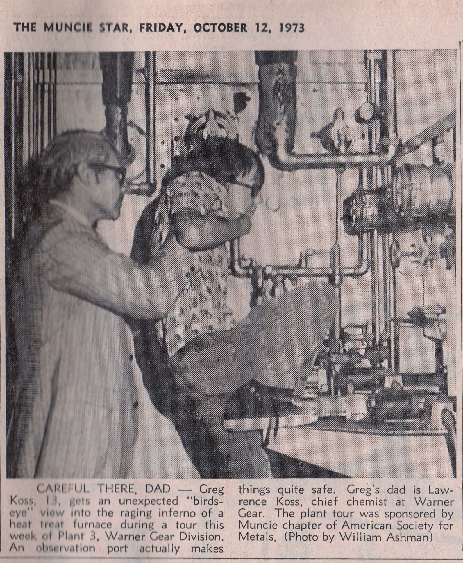 Father and son touring the plant in black and white photo