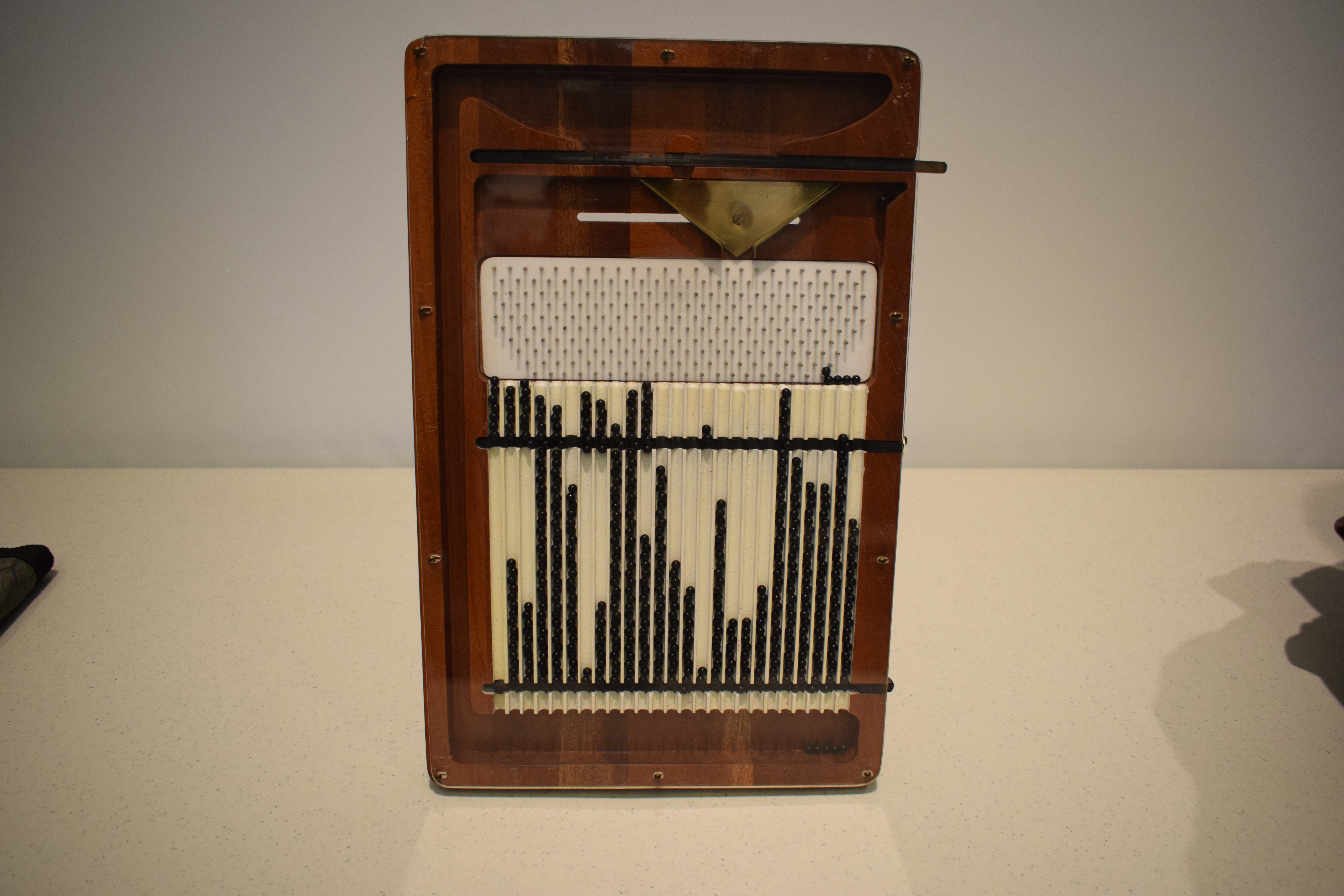 the quincunx is a tool used to show how frequency distributions are created in quality control training.