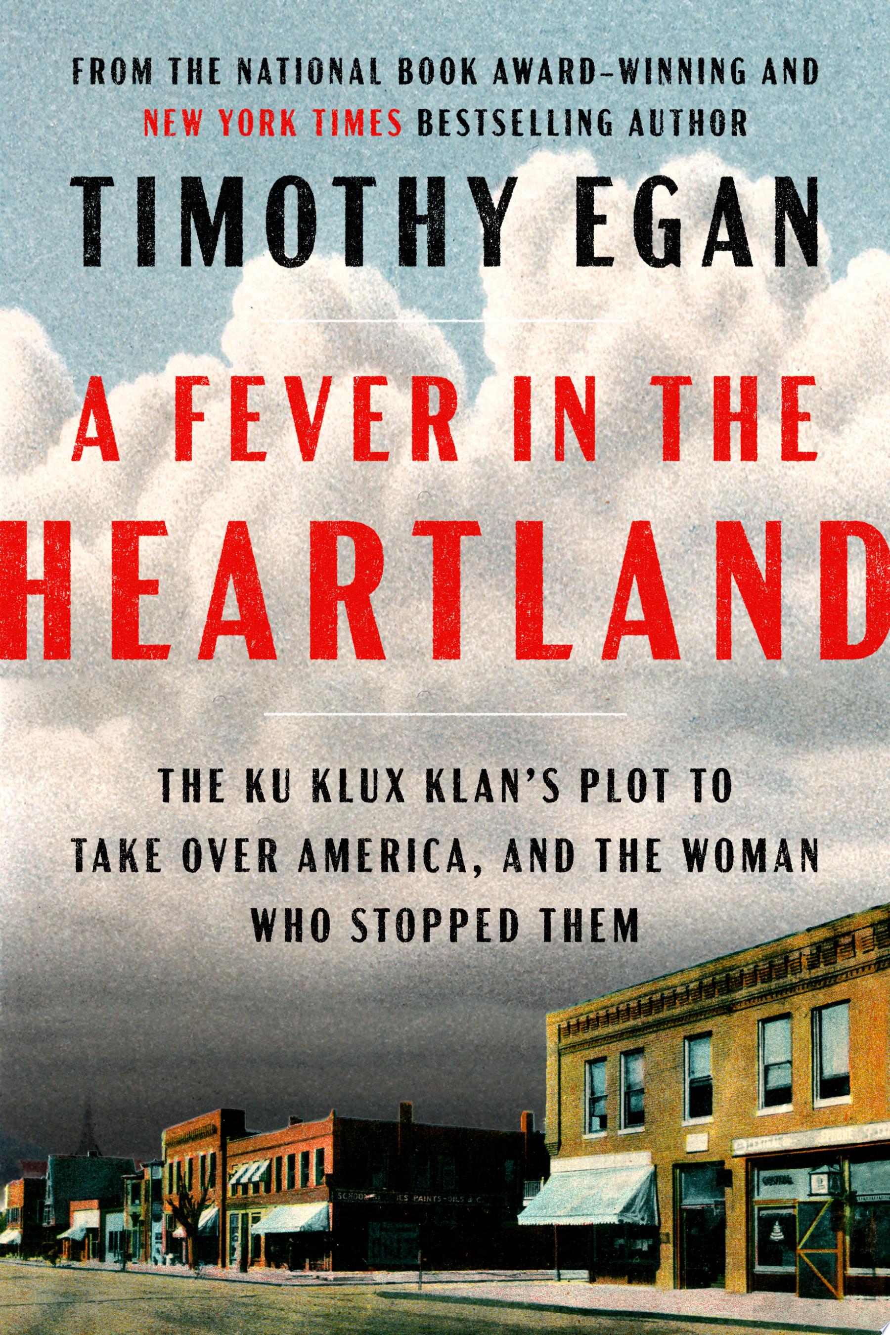 Book cover for A Fever in the Heartland by Timothy Egan, small town street and clouds on the cover.